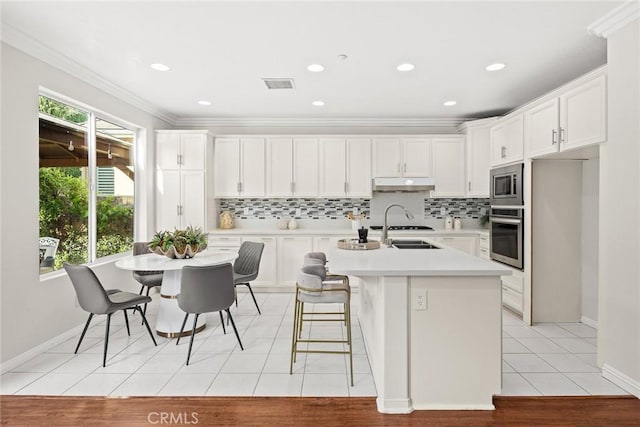 3612 Skylark Way, Brea, CA 92823 - kitchen featuring appliances with stainless steel finishes, decorative backsplash, light countertops, white cabinetry, and crown molding
