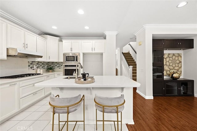 3612 Skylark Way, Brea, CA 92823 - kitchen with under cabinet range hood, a sink, appliances with stainless steel finishes, light countertops, and recessed lighting