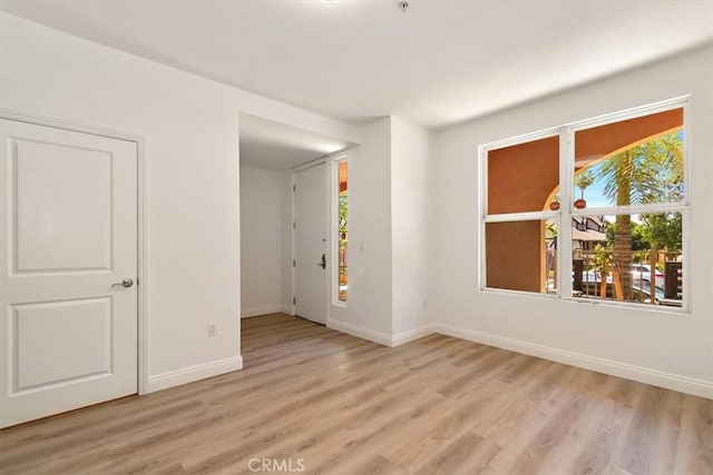 89 E Commonwealth Ave Unit 1I, Alhambra, CA 91801 - unfurnished room featuring healthy amount of natural light, light wood-style floors, and baseboards