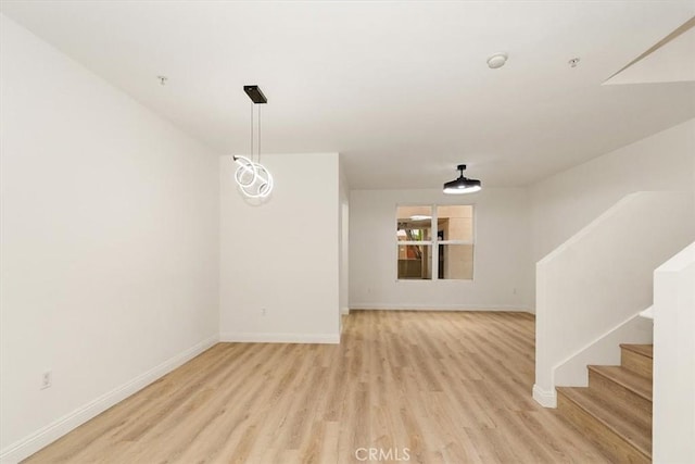 89 E Commonwealth Ave Unit 1I, Alhambra, CA 91801 - unfurnished room with light wood-style floors, baseboards, and stairs