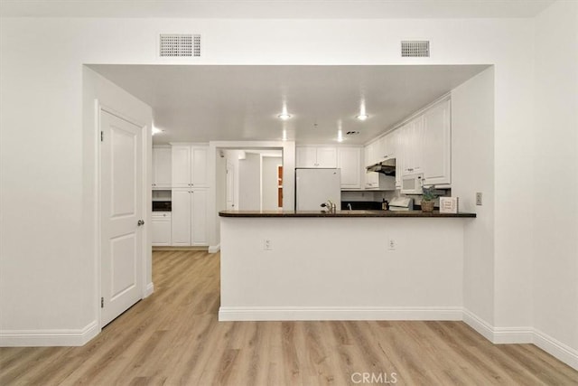 89 E Commonwealth Ave Unit 1I, Alhambra, CA 91801 - kitchen featuring white appliances, light wood finished floors, dark countertops, and white cabinets