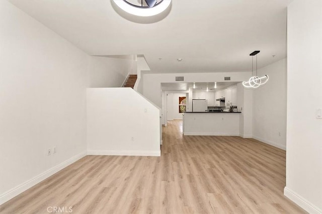 89 E Commonwealth Ave Unit 1I, Alhambra, CA 91801 - unfurnished living room featuring light wood-style floors and baseboards