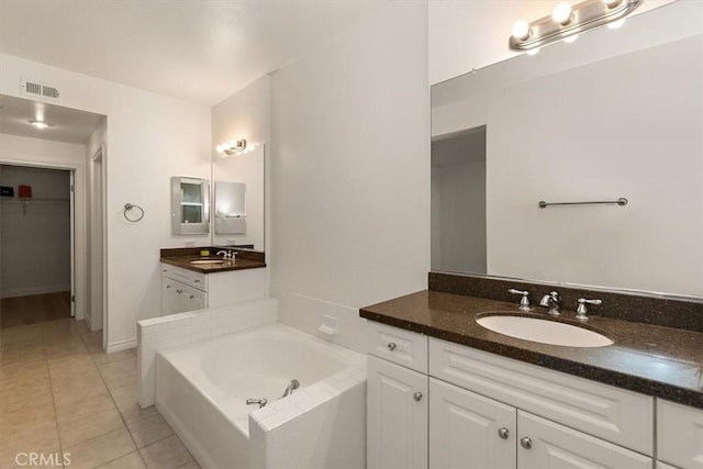 89 E Commonwealth Ave Unit 1I, Alhambra, CA 91801 - bathroom with tile patterned floors, vanity, a garden tub, and a walk in closet