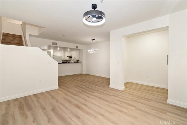 89 E Commonwealth Ave Unit 1I, Alhambra, CA 91801 - unfurnished living room with light wood-style floors, stairway, and baseboards
