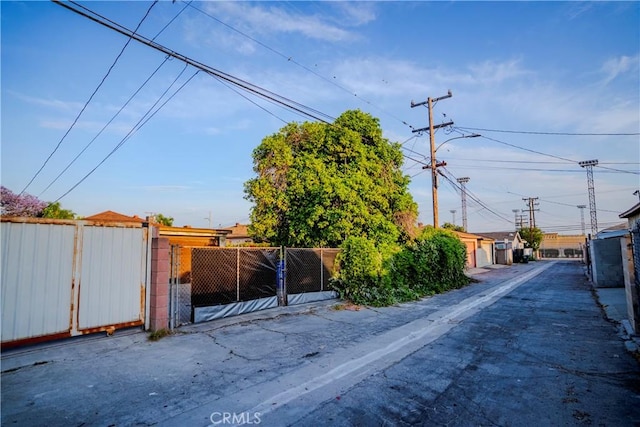 317 N 19th St, Montebello, CA 90640 - view of asphalt road featuring a gate and street lights