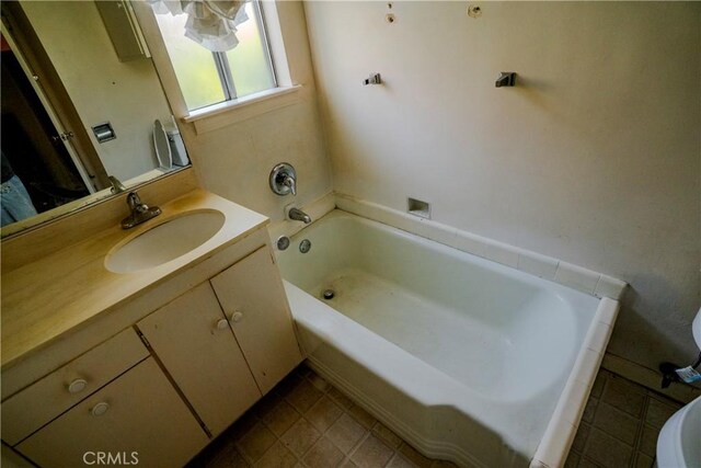 317 N 19th St, Montebello, CA 90640 - full bath with a tub to relax in, vanity, tile patterned floors, and toilet