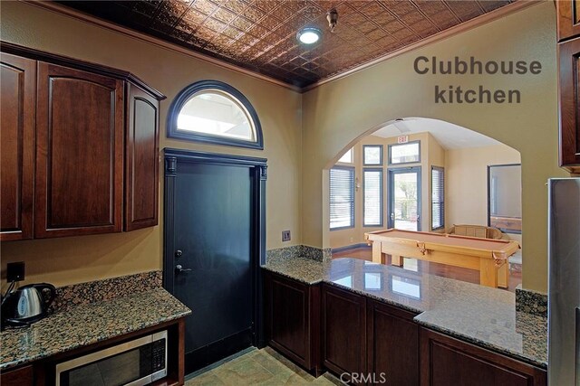 13365 Cloudburst Dr, Corona, CA 92883 - kitchen featuring stainless steel microwave, ornamental molding, arched walkways, an ornate ceiling, and dark brown cabinetry