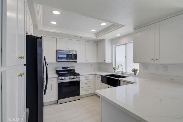 13365 Cloudburst Dr, Corona, CA 92883 - kitchen with appliances with stainless steel finishes, a raised ceiling, recessed lighting, white cabinets, and light stone counters