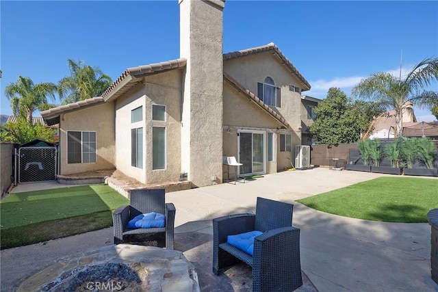 13365 Cloudburst Dr, Corona, CA 92883 - back of property featuring a chimney, stucco siding, a patio, and a fenced backyard