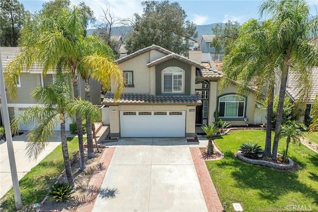 13365 Cloudburst Dr, Corona, CA 92883 - mediterranean / spanish house with a tiled roof, driveway, stucco siding, a garage, and a front lawn