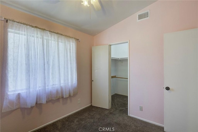 13365 Cloudburst Dr, Corona, CA 92883 - unfurnished bedroom with vaulted ceiling, carpet flooring, a walk in closet, a closet, and a ceiling fan