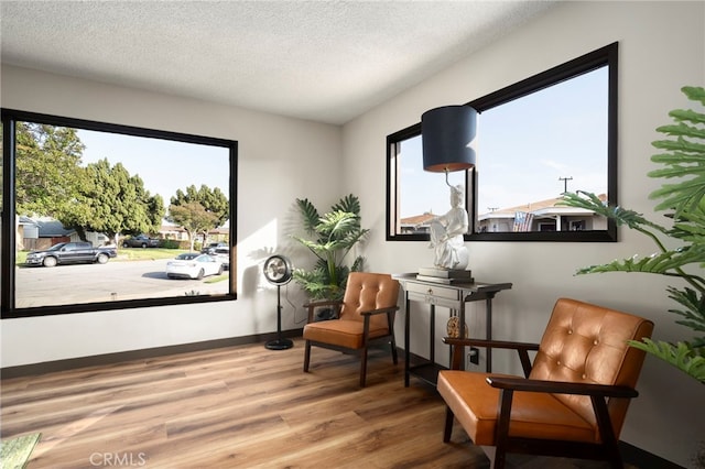 1409 N Midsite Ave, Covina, CA 91722 - sitting room with wood finished floors, a textured ceiling, and baseboards