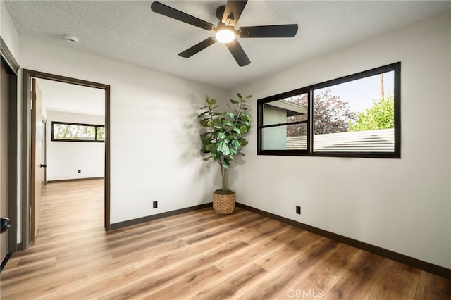 1409 N Midsite Ave, Covina, CA 91722 - unfurnished room featuring light wood finished floors, baseboards, a ceiling fan, and a textured ceiling