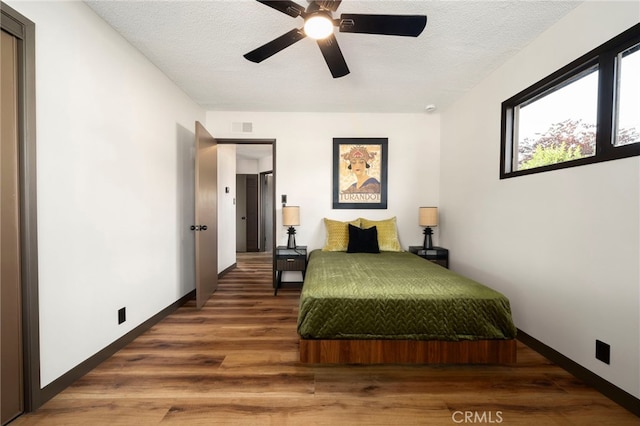 1409 N Midsite Ave, Covina, CA 91722 - bedroom with wood finished floors, a textured ceiling, baseboards, and a ceiling fan