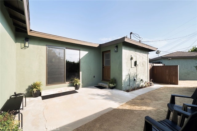 1409 N Midsite Ave, Covina, CA 91722 - back of property with stucco siding and a patio area