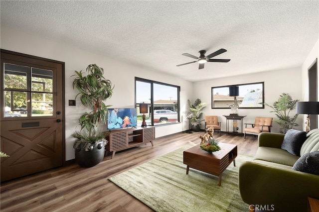 1409 N Midsite Ave, Covina, CA 91722 - living area featuring a textured ceiling, wood finished floors, and ceiling fan