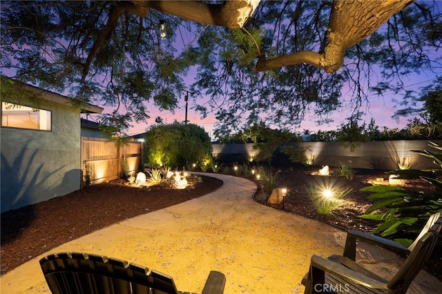 1409 N Midsite Ave, Covina, CA 91722 - patio terrace at dusk featuring an outdoor fire pit, a fenced backyard, and a patio