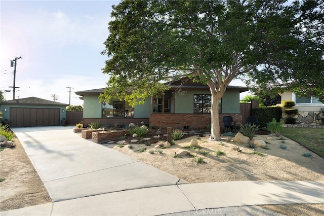 1409 N Midsite Ave, Covina, CA 91722 - view of front facade featuring brick siding, stucco siding, an outdoor structure, and a detached garage