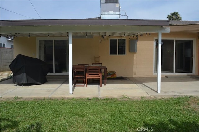 10407 Danube Ave, Granada Hills, CA 91344 - rear view of property featuring a patio, stucco siding, central air condition unit, and a lawn