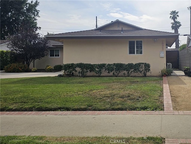 10407 Danube Ave, Granada Hills, CA 91344 - view of property exterior with stucco siding, a lawn, roof with shingles, and cooling unit