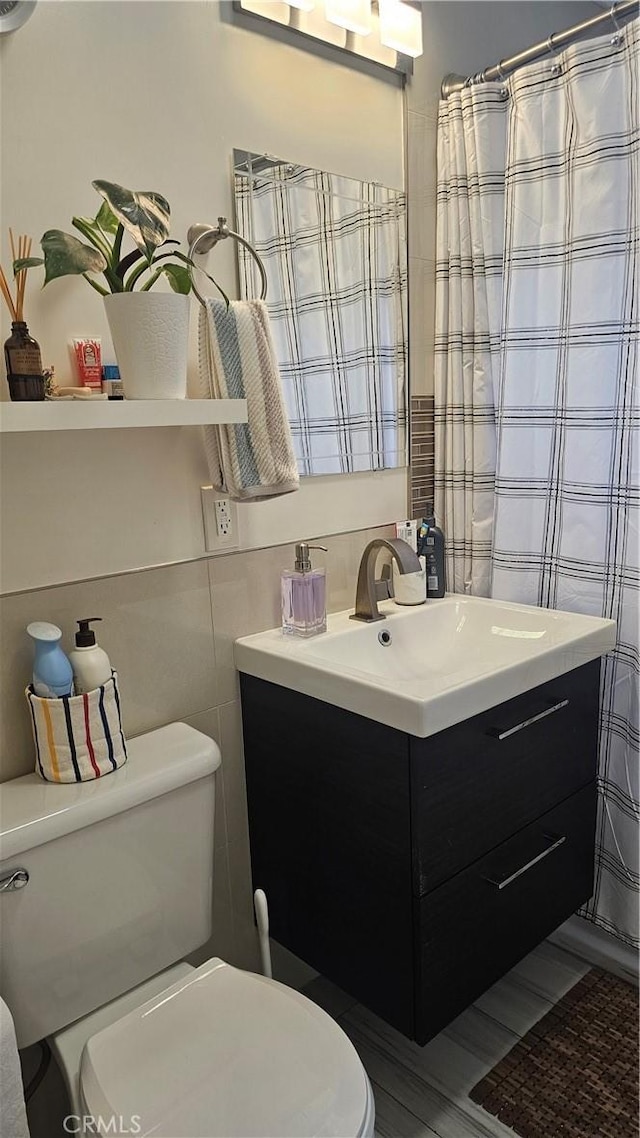 10407 Danube Ave, Granada Hills, CA 91344 - bathroom with toilet, vanity, and tile walls