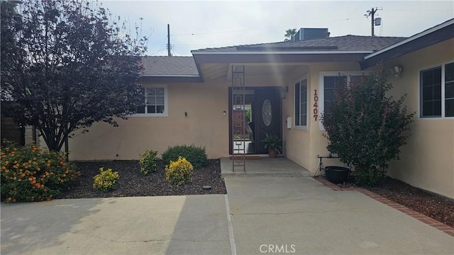 10407 Danube Ave, Granada Hills, CA 91344 - view of exterior entry with stucco siding and a shingled roof