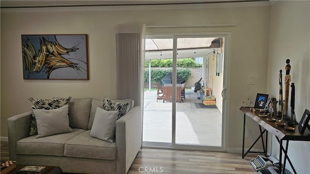 10407 Danube Ave, Granada Hills, CA 91344 - living room featuring wood finished floors, baseboards, and crown molding
