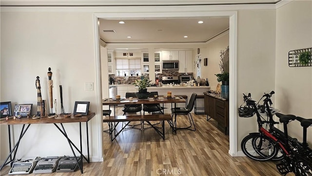 10407 Danube Ave, Granada Hills, CA 91344 - dining area featuring wood finished floors, crown molding, recessed lighting, and baseboards