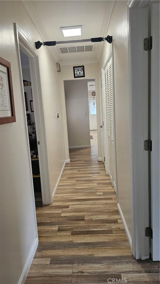 10407 Danube Ave, Granada Hills, CA 91344 - hall with wood finished floors, crown molding, and baseboards