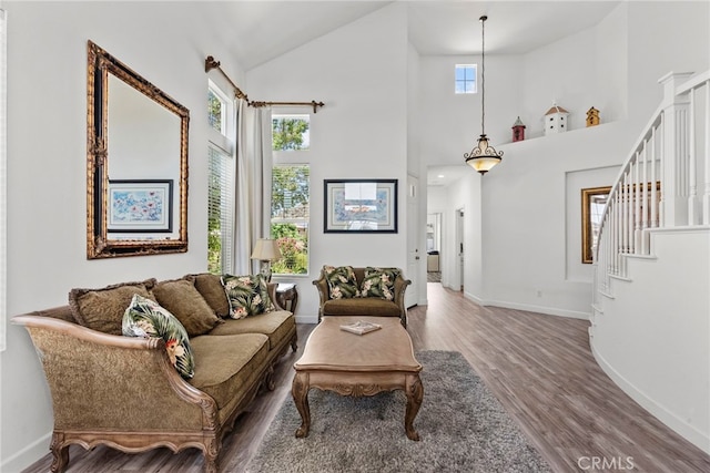 28809 Garnet Canyon Dr, Saugus, CA 91390 - living room featuring wood finished floors, plenty of natural light, baseboards, and high vaulted ceiling