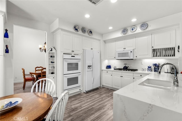 28809 Garnet Canyon Dr, Saugus, CA 91390 - kitchen featuring white appliances, a sink, white cabinets, light wood-type flooring, and a chandelier