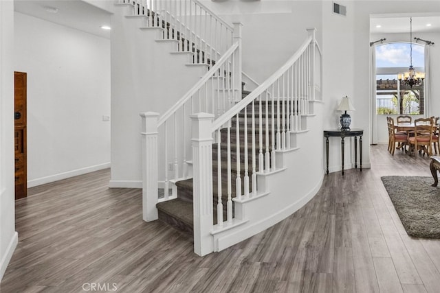 28809 Garnet Canyon Dr, Saugus, CA 91390 - stairs featuring wood finished floors, a chandelier, baseboards, recessed lighting, and a high ceiling