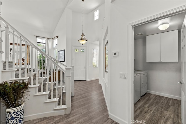28809 Garnet Canyon Dr, Saugus, CA 91390 - foyer entrance with separate washer and dryer, baseboards, wood finished floors, stairway, and a towering ceiling