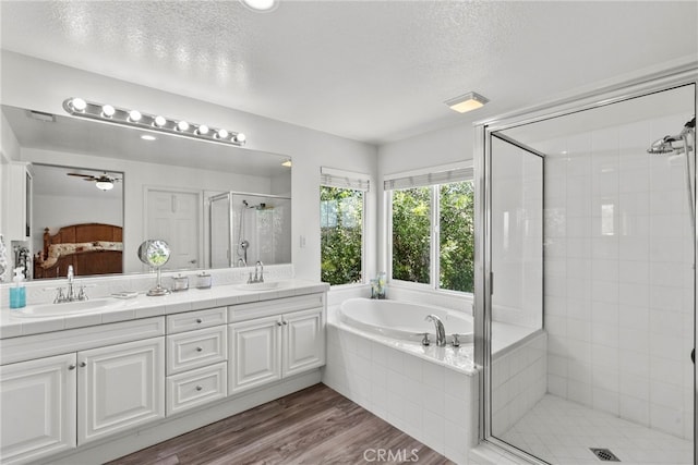 28809 Garnet Canyon Dr, Saugus, CA 91390 - full bathroom featuring a shower stall, a bath, connected bathroom, double vanity, and a textured ceiling
