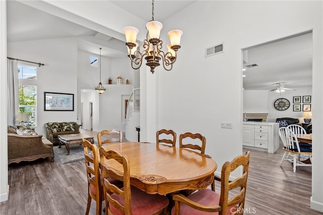28809 Garnet Canyon Dr, Saugus, CA 91390 - dining room with stairs, light wood finished floors, a ceiling fan, high vaulted ceiling, and a chandelier