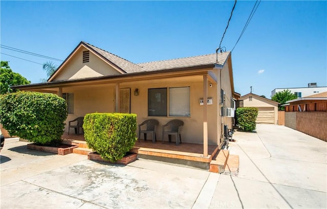 14127 Daubert St, San Fernando, CA 91340 - view of front of property featuring stucco siding, covered porch, an outdoor structure, and a shingled roof