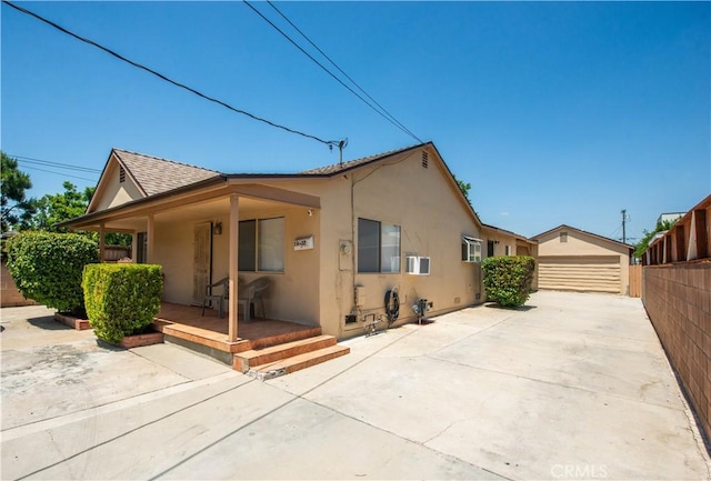 14127 Daubert St, San Fernando, CA 91340 - view of front of house featuring stucco siding, a porch, an outbuilding, and a shingled roof