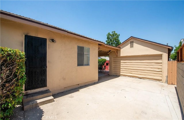 14127 Daubert St, San Fernando, CA 91340 - view of home's exterior featuring stucco siding and a garage