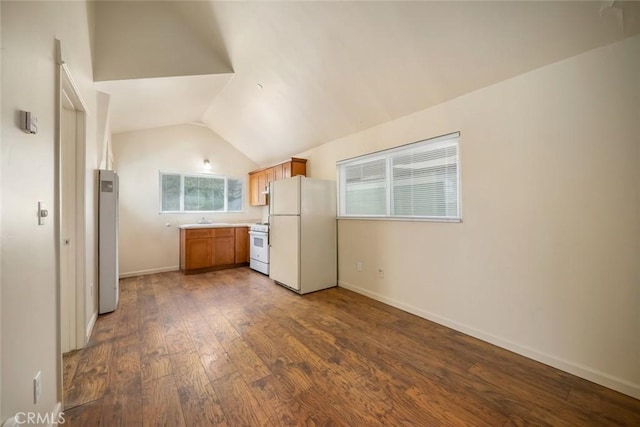 8740 El Camino Real Unit A, Atascadero, CA 93422 - kitchen featuring white appliances, dark wood finished floors, lofted ceiling, light countertops, and baseboards