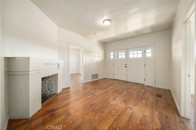 8740 El Camino Real Unit A, Atascadero, CA 93422 - foyer entrance with hardwood / wood-style flooring, a brick fireplace, and baseboards