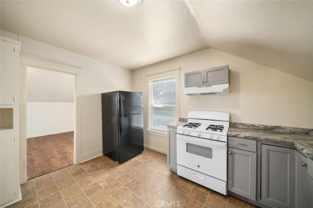 8740 El Camino Real Unit A, Atascadero, CA 93422 - kitchen with freestanding refrigerator, white gas range, gray cabinetry, under cabinet range hood, and vaulted ceiling