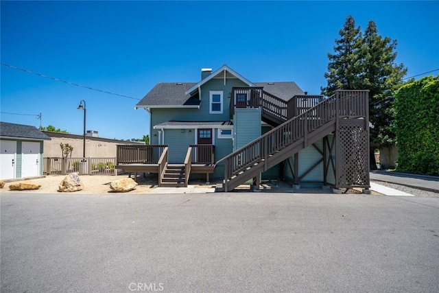 8740 El Camino Real Unit A, Atascadero, CA 93422 - view of front of house with stairs, a wooden deck, and a chimney