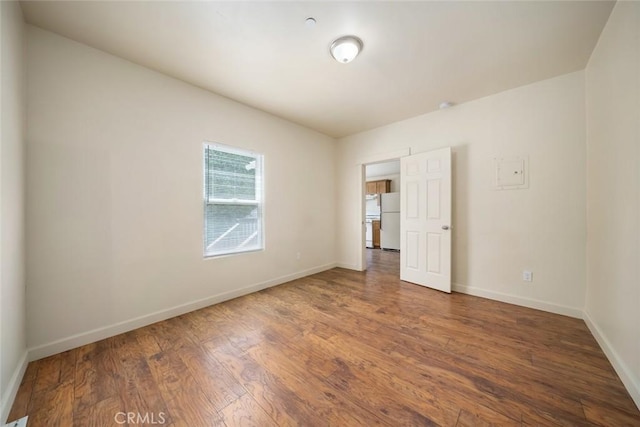 8740 El Camino Real Unit A, Atascadero, CA 93422 - unfurnished bedroom with freestanding refrigerator, wood finished floors, and baseboards