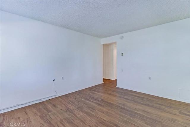 382 Avenida Castilla Unit B, Laguna Woods, CA 92637 - spare room with wood finished floors and a textured ceiling