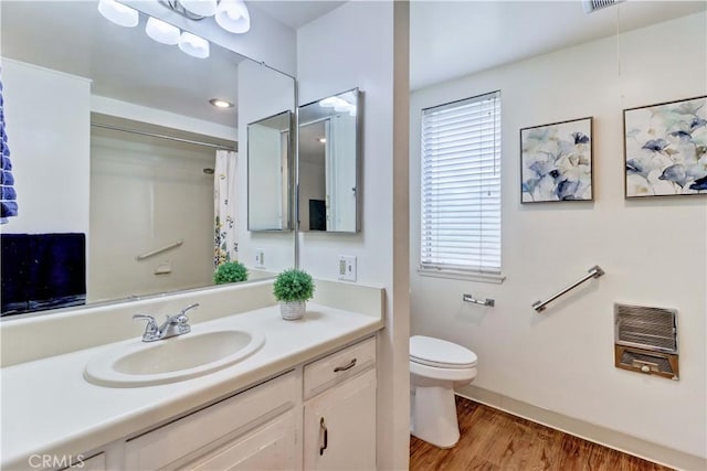 382 Avenida Castilla Unit B, Laguna Woods, CA 92637 - full bathroom featuring heating unit, vanity, toilet, wood finished floors, and baseboards