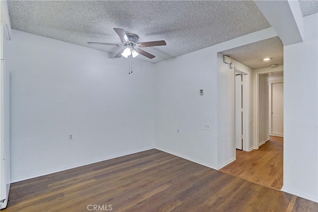 382 Avenida Castilla Unit B, Laguna Woods, CA 92637 - spare room with a textured ceiling, a ceiling fan, wood finished floors, and baseboards