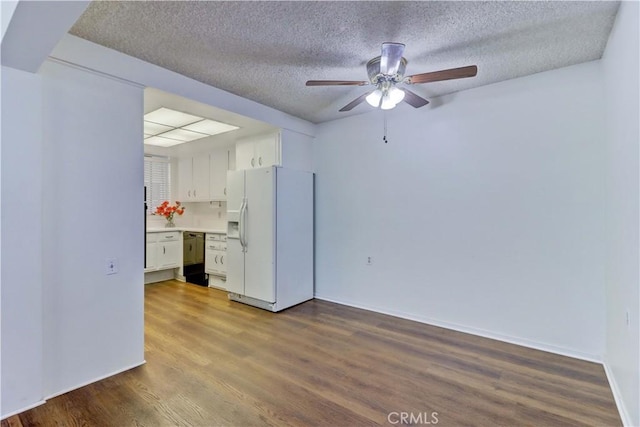 382 Avenida Castilla Unit B, Laguna Woods, CA 92637 - empty room with a ceiling fan, dark wood-style flooring, a textured ceiling, and baseboards