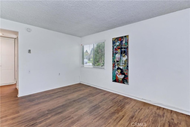 382 Avenida Castilla Unit B, Laguna Woods, CA 92637 - spare room with wood finished floors, a textured ceiling, and baseboards