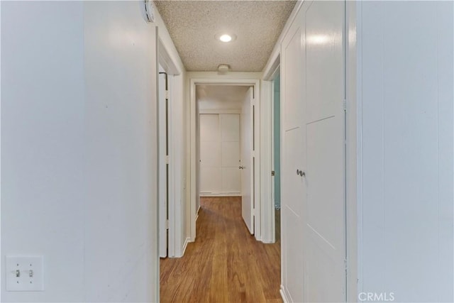 382 Avenida Castilla Unit B, Laguna Woods, CA 92637 - corridor with light wood-type flooring, recessed lighting, and a textured ceiling