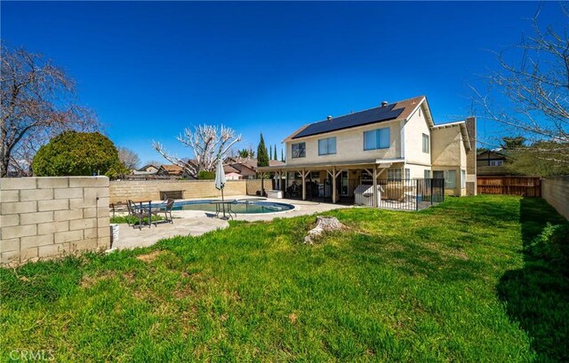 44419 Fenhold, Lancaster, CA 93535 - back of house featuring a patio area, roof mounted solar panels, a fenced backyard, and stucco siding
